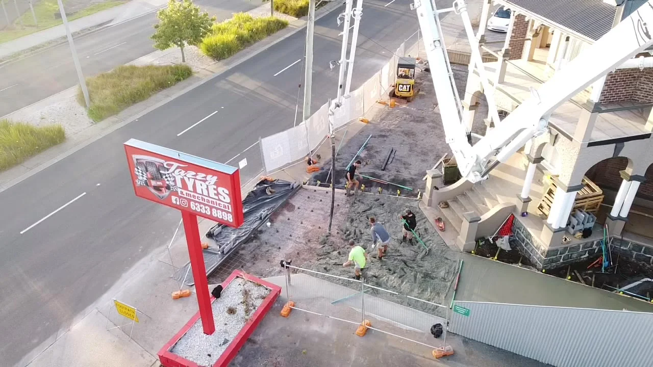 Aerial view of the driveway concrete pour with boom pump and crew