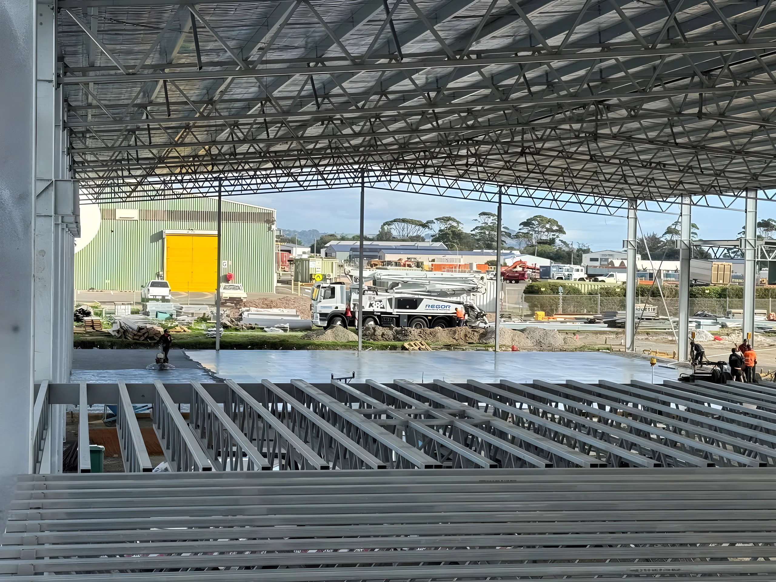 Steel frame and concrete slab of a large commercial shed built on earthworks by LCB Contracting, Devonport