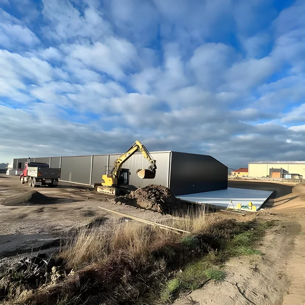 Excavator finishing a commercial shed pad in North West Tasmania