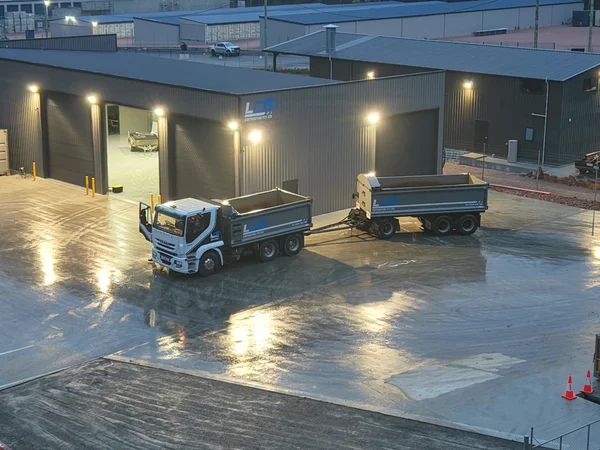 LCB truck and dog trailer at the depot shed at dusk